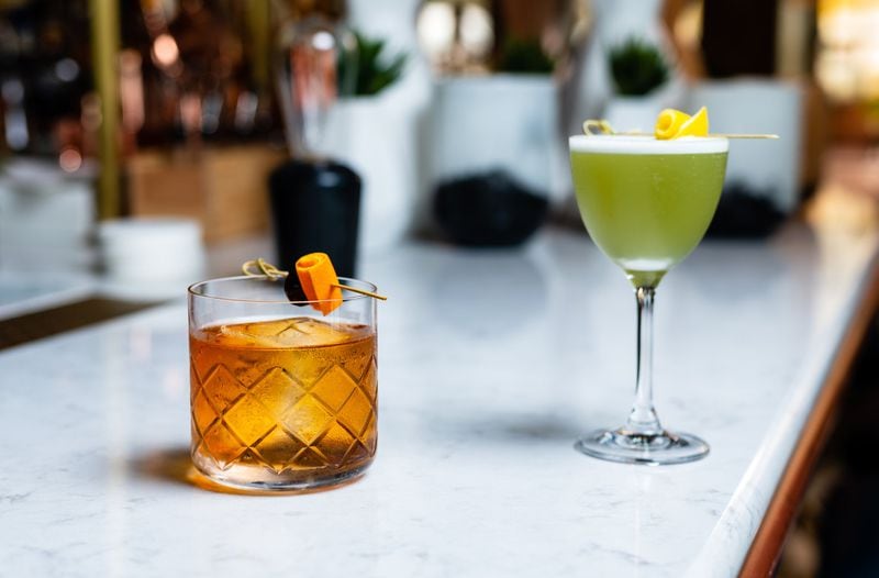 Two cocktails from Aix in West Midtown — the Howard’s Old-Fashioned (left) and the Prince of the Sun (right). CONTRIBUTED BY HENRI HOLLIS