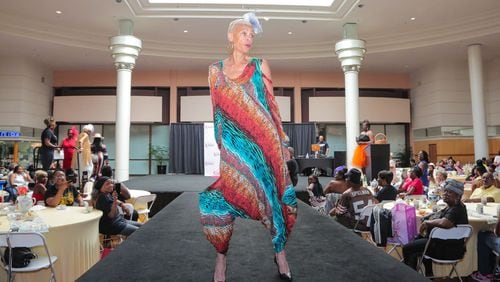 A model wearing a colorful dress struts on the catwalk at the 'Seniors on the Runway' event on May 4, 2024, at Greenbriar Mall in Atlanta.