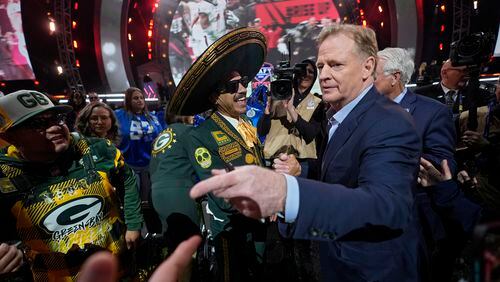 NFL Commissioner Roger Goodell meets with Green Bay Packers fans during the first round of the NFL football draft, Thursday, April 25, 2024, in Detroit. (AP Photo/Paul Sancya)