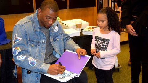 Malcolm Mitchell, former UGA player and current New England Patriot, signed copies of his children’s book, “The Magician’s Hat,” Saturday afternoon in Atlanta. (Alexis Stevens/astevens@ajc.com)
