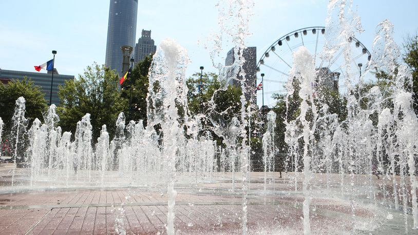 July 20, 2016 Atlanta: The Fountain of Rings plash in front of Atlanta skyscrapers and the SkyView ferris wheel in Centennial Olympic Park on Wednesday, July 20, 2016. This year Atlanta is celebrating the 20th anniversary of the 1996 Olympic Games. EMILY JENKINS/ EJENKINS@AJC.COM