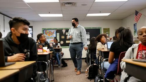 FILE - Social studies teacher Daniel Garcia interacts with seventh-grade students at Shiloh Middle School on Tuesday, October 18, 2022.  (Miguel Martinez / miguel.martinezjimenez@ajc.com)