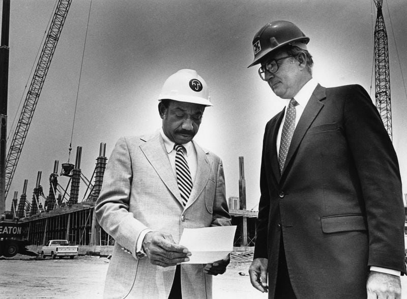 Herman J. Russell (from left) and Bob Holder at the construction site of the Delta building near Virginia Avenue in Atlanta on Aug. 8, 1983. LANNA SWINDLER / THE ATLANTA JOURNAL-CONSTITUTION