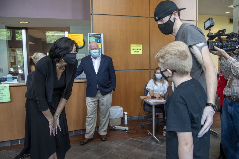 In this May 2021, file photo Dr. Rochelle Walensky, left, Director of the Centers for Disease Control and Prevention, greets 12-year-old Larry Hall while visiting the Whitfield County Health Department in Dalton. (Alyssa Pointer / Alyssa.Pointer@ajc.com)