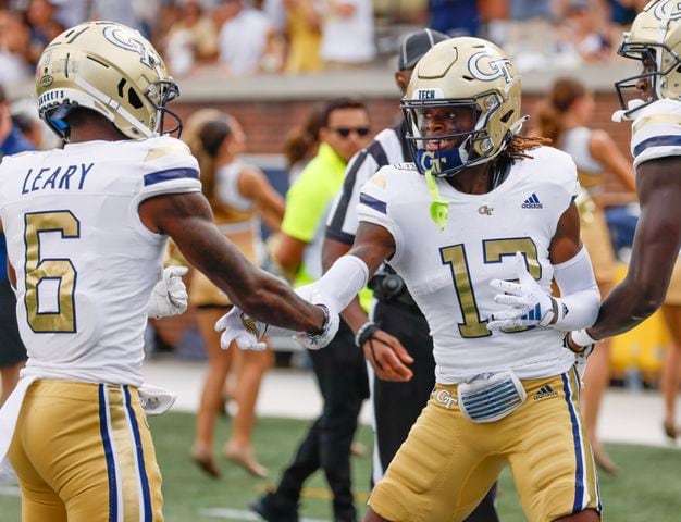 Georgia Tech Yellow Jackets wide receiver Eric Singleton Jr. (13) celebrates his first half touchdown with  wide receiver Christian Leary (6) and wide receiver Abdul Janneh (18) during a football game against South Carolina State at Bobby Dodd Stadium in Atlanta on Saturday, September 9, 2023.   (Bob Andres for the Atlanta Journal Constitution)