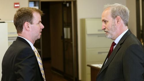 Stefan Ritter, (right) executive director of the state ethics commission, is trying to get local officials to pay up fees they’ve been assessed for failing to file documents like campaign reports on time. BOB ANDRES / BANDRES@AJC.COM