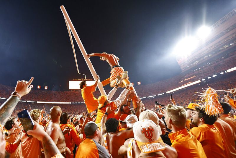 Fans tear down a goal post after an NCAA college football game between Tennessee and Alabama Saturday, Oct. 15, 2022, in Knoxville, Tenn. Tennessee won 52-49. (AP Photo/Wade Payne)