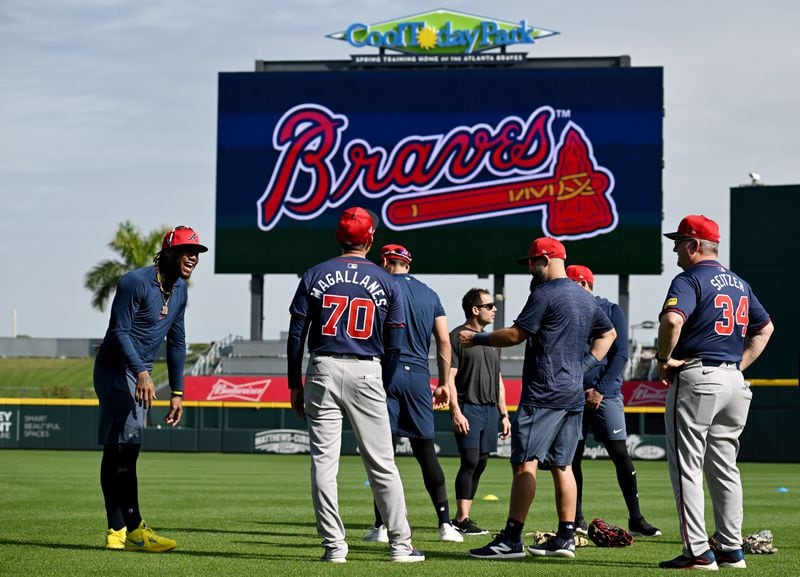 Atlanta Braves right fielder Ronald Acuna Jr. (left) smiles as he talks with assistant hitting coach Bobby Magallanes during spring training workouts at CoolToday Park, Friday, February, 16, 2024, in North Port, Florida. (Hyosub Shin / Hyosub.Shin@ajc.com)