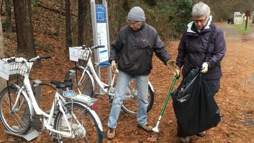 Carol Schneier, left, and Mary Kimberly pick up trash in the Chattahoochee River National Recreation Area's Paces Mill Unit. Photo: Jennifer Brett