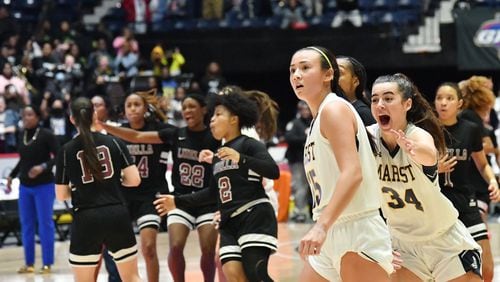 Marist's Lexy Faklaris (34) congratulates Marist's Avery Fantucci (25) as she reacts after scoring a 3-point basket to tie the game at the end of the 4th quarter during the 2022 GHSA State Basketball Championship game at the Macon Centreplex in Macon on Wednesday, March 9, 2022. Marist won 56-54 over Luella in double overtime. (Hyosub Shin/hshin@ajc.com)