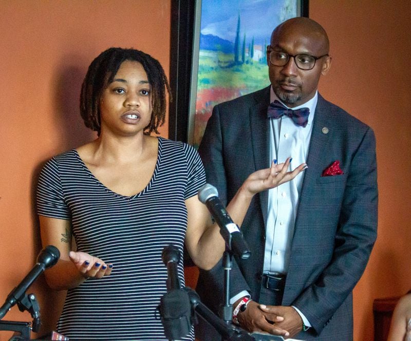 Amber Jackson, standing next to her lawyer Mawuli Davis, talks during a press conference in Decatur on Friday, June 25, 2021, concerning her body-slam lawsuit against two Atlanta police officers and the city of Atlanta. (STEVE SCHAEFER FOR THE ATLANTA JOURNAL-CONSTITUTION)