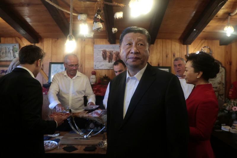 Chinese President Xi Jinping and his wife Peng Liyuan, right, with French President Emmanuel Macron enjoy a moment in a restaurant, Tuesday, May 7, 2024 at the Tourmalet pass, in the Pyrenees mountains. French president is hosting China's leader at a remote mountain pass in the Pyrenees for private meetings, after a high-stakes state visit in Paris dominated by trade disputes and Russia's war in Ukraine. French President Emmanuel Macron made a point of inviting Chinese President Xi Jinping to the Tourmalet Pass near the Spanish border, where Macron spent time as a child visiting his grandmother. (AP Photo/Aurelien Morissard, Pool)