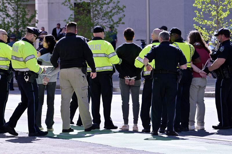 Police detain three a pro-Palestinian demonstrators who attempted to block traffic to the garage of the Stata Center at MIT, Thursday, May 9, 2024, in Cambridge, Mass. (AP Photo/Josh Reynolds)