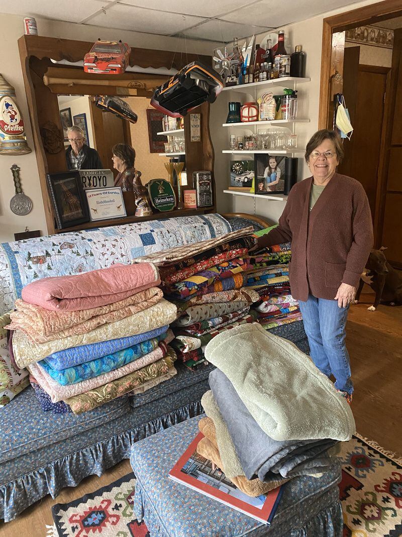Elleda Rule, a  member of the Nesty sewing circle, shows off some of the quilts created by her group. Photo: Jenni Girtman