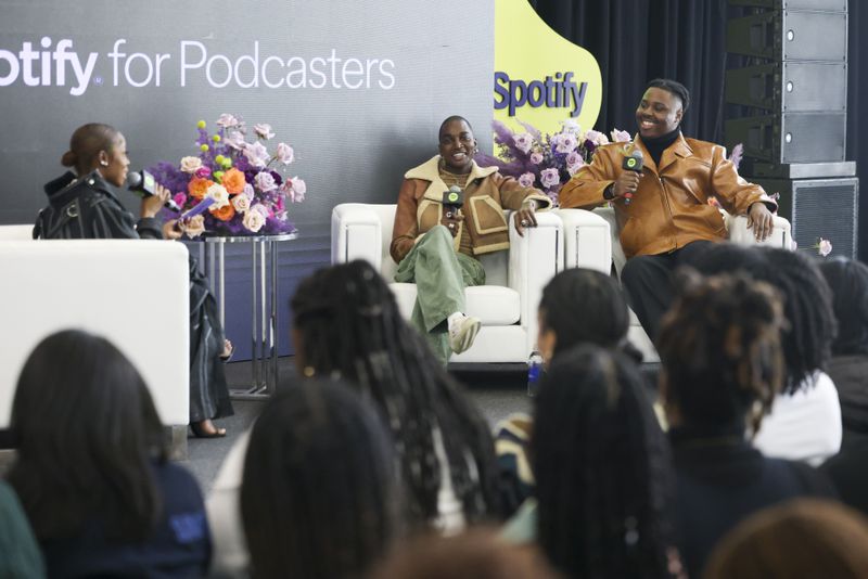 Rickey Thompson, center, and Denzel Dion, right, of the podcast, “We Said What We Said with Rickey and Denzel,” answer questions from moderator Wunmi Bello, left, during Spelman Creator Day at the Wellness Center Gymnasium at Spelman College, Monday, March 20, 2023, in Atlanta. Jason Getz / Jason.Getz@ajc.com)

