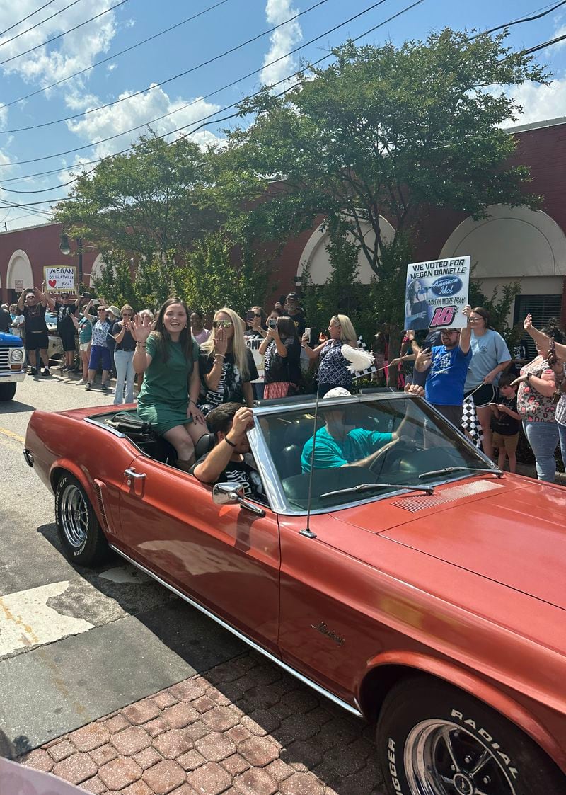 Megan Danielle (left) in a Mustang during the parade held by "American Idol" in her hometown Douglasville May 16, 2023. RODNEY HO/rho@ajc.com