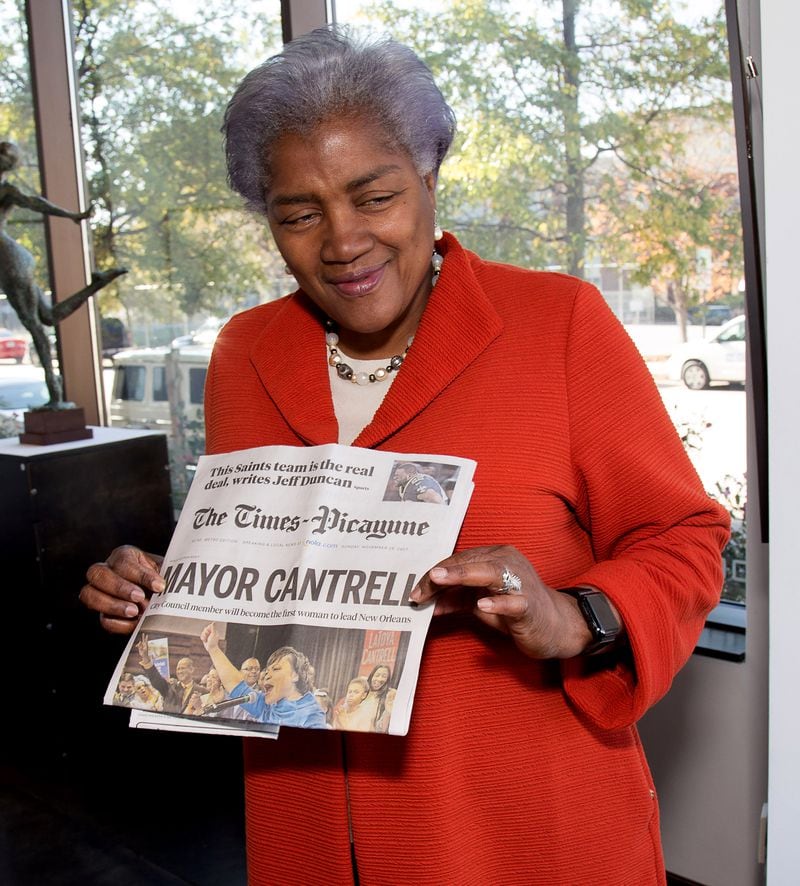Donna Brazile, the author of the new book "Hacks," holds up the front page of LaToya Cantrell winning the New Orleans mayor race at her book signing at ZuCot Gallery in Atlanta GA November 19, 2017. STEVE SCHAEFER / SPECIAL TO THE AJC