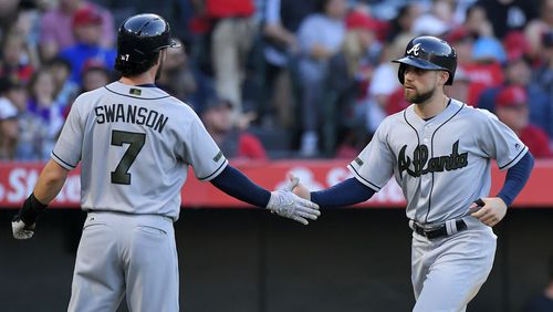 Atlanta Braves’ Dansby Swanson (left) and Ender Inciarte congratulate each other after they scored on a ground-rule double by Matt Adams during the third inning against the Los Angeles Angels, Monday, May 29, 2017, in Anaheim, Calif. (AP Photo/Mark J. Terrill)