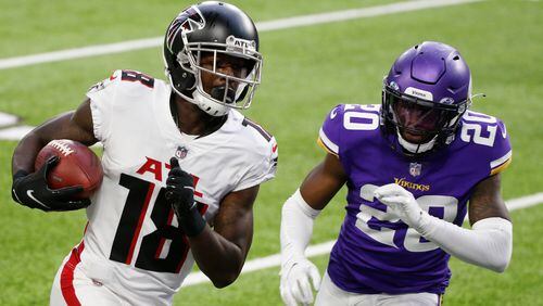 Falcons wide receiver Calvin Ridley (18) runs from Minnesota Vikings cornerback Jeff Gladney (20) during an 8-yard touchdown reception during the first half Sunday, Oct. 18, 2020, in Minneapolis. (Bruce Kluckhohn/AP)