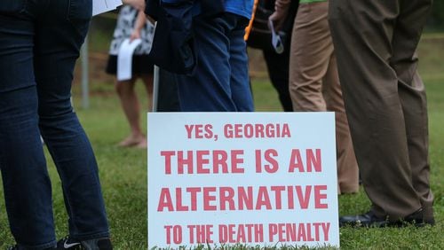 Death penalty opponents gathered in a circle outside the Georgia Diagnostic and Classification State Prison in Jackson on April 27, 2016, when Daniel Anthony Lucas was executed for the 1998 murders of a Jones County father and his two children. Ben Gray / bgray@ajc.com