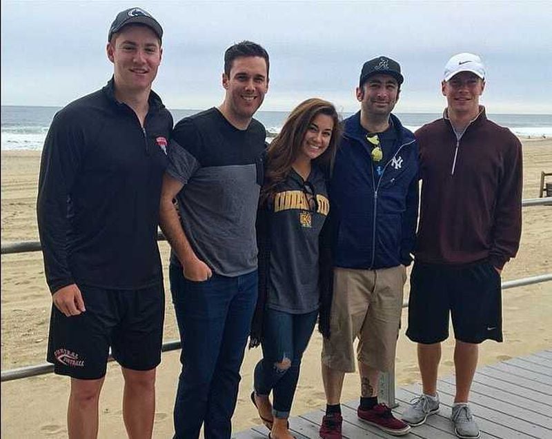 Kennesaw State University student Juliana Piazza (center), poses with her cousin, Timothy, (on the left wearing a baseball cap) who died after a hazing incident at Penn State University, and others. Piazza, 22, is working to end hazing on college campuses. PHOTO CONTRIBUTED.
