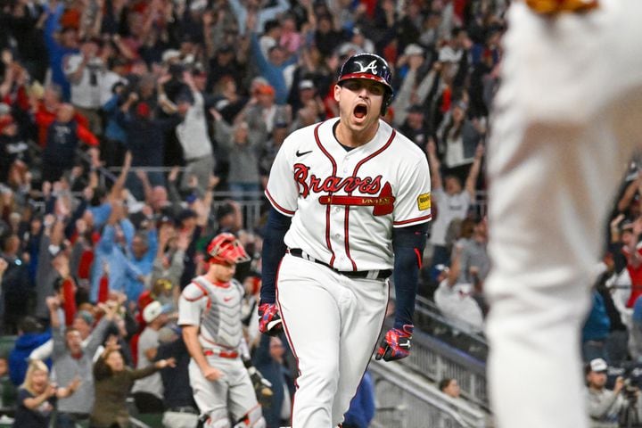 Atlanta Braves’ Austin Riley (27) celebrates a two-run home run against the Philadelphia Phillies during the eighth inning of NLDS Game 2 in Atlanta on Monday, Oct. 9, 2023. The Braves won 5-4.   (Hyosub Shin / Hyosub.Shin@ajc.com)
