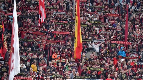 Atlanta United fans hold banners before the first round of the MLS playoffs between the Atlanta United and the New England Revolution at Mercedes-Benz Stadium on Saturday, October 19, 2019. Atlanta United won 1-0 over the New England Revolution. (Hyosub Shin / Hyosub.Shin@ajc.com)