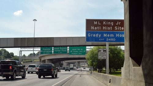 Signs directing motorists to the Carter Center and the MLK Memorial are shown along the downtown connector, Thursday, May 29, 2014. The National Parks Service is negotiating with the Georgia Department of Transportation on altering the placement of signs directing tourists to the King Center. They say the current placement forces tourists to make an abrupt exit from the highway.