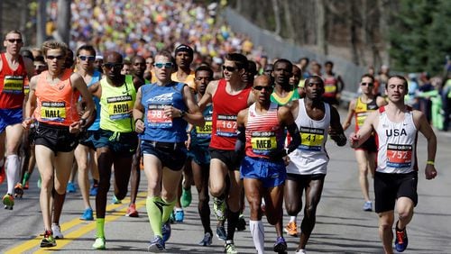 In this April 21, 2014, file photo, runners compete in the 118th Boston Marathon in Hopkinton, Mass. The 120th running of the historic footrace is scheduled for Monday, April 18, 2016. (AP Photo/Steven Senne, File)