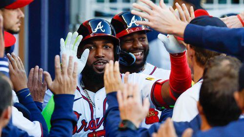Atlanta Braves designated hitter Marcell Ozuna celebrates with teammates as Michael Harris II follows after hitting a three-run home run during the first inning against the Texas Rangers at Truist Park on Sunday, April 21, 2024, in Atlanta.
(Miguel Martinez/ AJC)