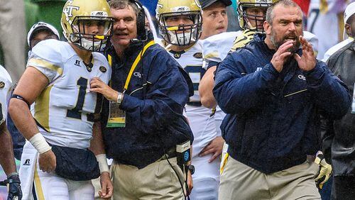 In this photo released by Georgia Tech, Georgia Tech coach Paul Johnson, second from left, gives quarterback Matthew Jordan (11) the next play during the first half of an NCAA college football game against Boston College, Saturday, Sept. 3, 2016, in Dublin, Ireland. (Danny Karnik/Georgia Tech via AP)