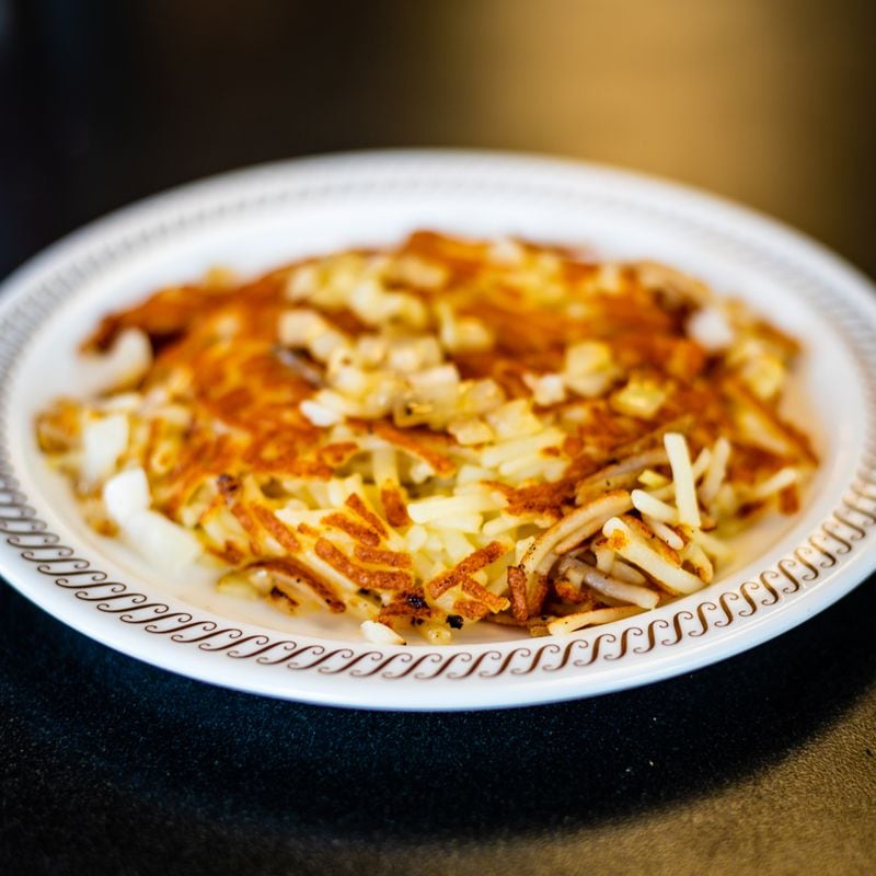 Smothered hash browns from Waffle House with grilled onions.
