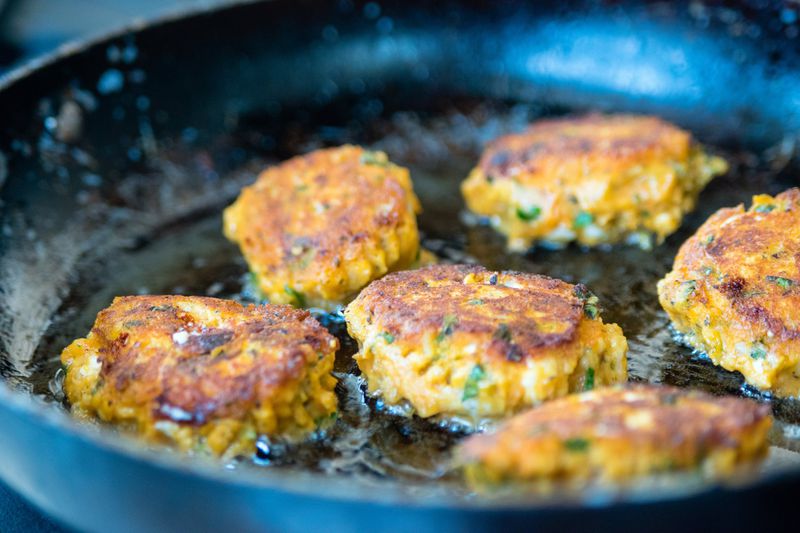 The sweet potato fritters are pan-fried til they have a golden, crunchy crust. CONTRIBUTED BY HENRI HOLLIS