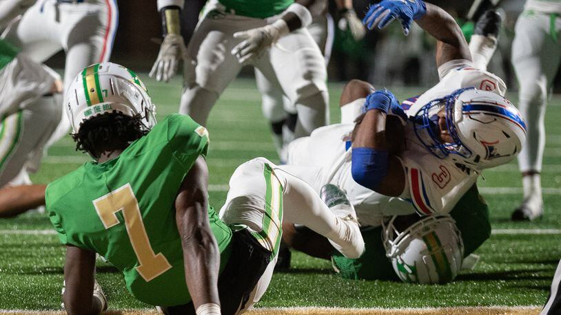 Makari Bodiford, running back for Walton is tackled during the Walton vs. Buford High School Football game on Friday, Nov. 18, 2022, at Buford High School in Buford, Georgia. (Jamie Spaar for the Atlanta Journal Constitution)