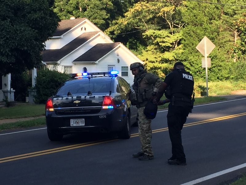 DeKalb County SWAT are outside a home where an armed person has barricaded himself inside.