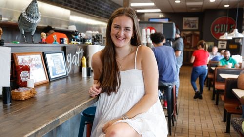Avery Graus, a senior at Marietta High School poses for a photo inside of Red Eyed Mule in Marietta on Thursday, May 23, 2024. Graus will be receiving free meals for life from the restaurant for having perfect attendance since kindergarten. (Natrice Miller/ AJC)