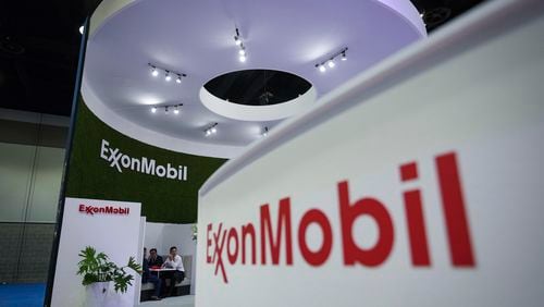 FILE - Delegates meet at the Exxon Mobil booth during the LNG2023 conference in Vancouver, British Columbia, Tuesday, July 11, 2023. Exxon Mobil reports their earnings Friday, April 26, 2024. (Darryl Dyck/The Canadian Press via AP, File)