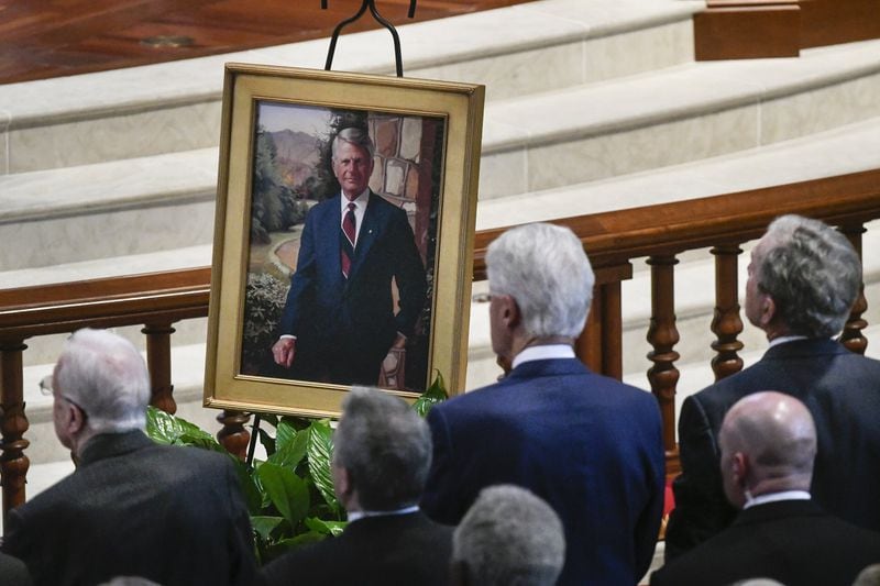 Former Presidents Jimmy Carter, left, Bill Clinton, front and center, and George W. Bush face a portrait of Zell Miller, the former Georgia governor and U.S. senator, as they attend his funeral Tuesday at Peachtree Road United Methodist Church in Atlanta. (John Amis)
