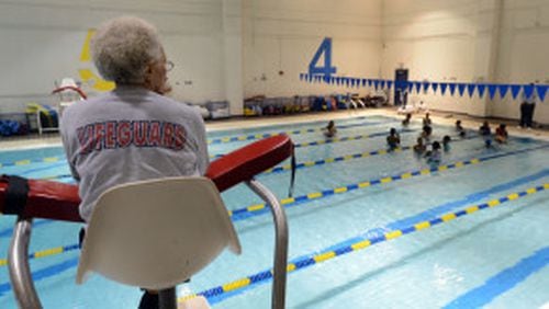 Lifeguard Emma Sistrunk keeps an eye on the pool as Martin Luther King Jr. Middle School students participate in a swimming lesson.