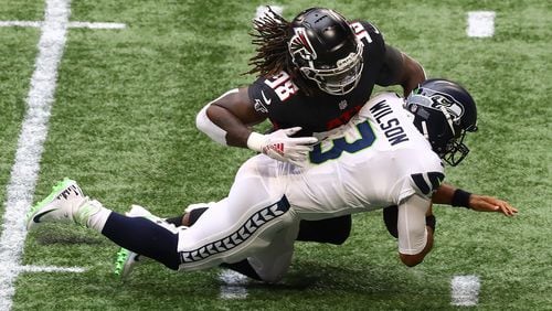Falcons defensive end Takk McKinley sacks Seattle Seahawks quarterback Russell Wilson on his first offensive play during the first quarter Sunday, Sept. 13, 2020 in Atlanta.  (Curtis Compton / Curtis.Compton@ajc.com)