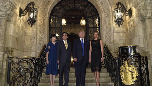 President Donald Trump, second from right, and first lady Melania Trump, right, stop to pose for a photo with Japanese Prime Minister Shinzo Abe, second from left, and his wife Akie Abe, left, before they have dinner at Mar-a-Lago in Palm Beach, Fla., Saturday, Feb. 11, 2017. (AP Photo/Susan Walsh)