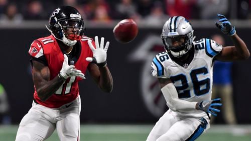 Atlanta Falcons wide receiver Julio Jones (11) hauls in a pass in front of Carolina Panthers cornerback Daryl Worley (26) during the second half Sunday December 31, 2017. Photo by Brant Sanderlin/AJC