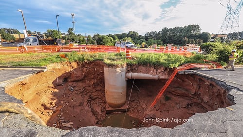 Sinkholes opened on Venture Drive between Steve Reynolds Boulevard and Pleasant Hill Road in Duluth, a block away from the Gwinnett Place Mall.