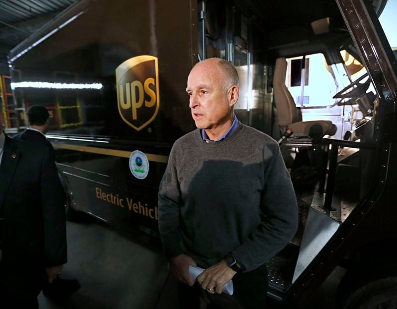 FILE PHOTO: California Gov. Jerry Brown talks to reporters after inspecting an electric-powered UPS delivery truck at the UPS distribution center in West Sacramento, Calif., Tuesday, Feb. 5, 2013. Brown appeared at the facility to mark the deployment of 100 of the company's zero-emission, electric delivery vehicle fleet.
