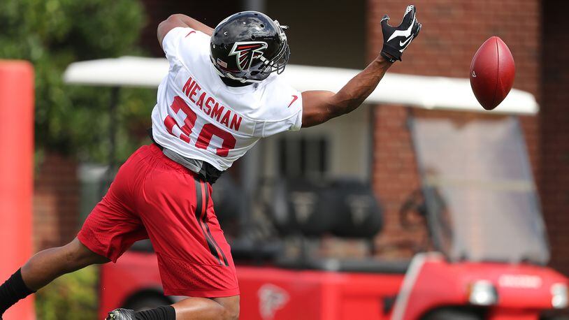 Falcons rookie free safety Sharrod Neasman just misses picking off a pass off his fingertips during the first day of training camp on Thursday, July 28, 2016, in Flowery Branch.   Curtis Compton /ccompton@ajc.com
