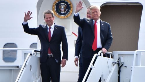 November 4, 2018 Macon - GOP gubernatorial candidate Brian Kemp and President Donald Trump wave from Air Force One as President Donald J. Trump arrives during President Donald J. Trump's Make America Great Again Rally to support Brian Kemp at Middle Georgia Regional Airport in MaconSunday, November 4, 2018. HYOSUB SHIN / HSHIN@AJC.COM
