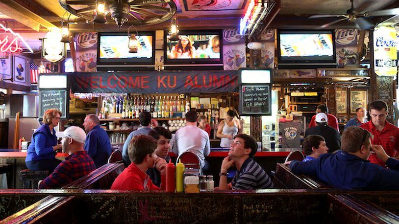 The Wheel in Lawrence, Kan., Oct. 10, 2015. Not far from the University of Kansas, the restaurant and bar, known for its wang burger and its 15 televisions, does not draw a lot of football fans when the school’s team plays (and often loses), but owner Robert Farha endures while he waits for basketball season and the customers that will come with it, eager to watch a traditional winner. (Christopher Smith/The New York Times)