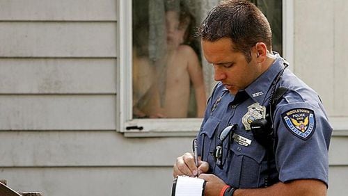 Middletown, Ohio, patrol officer Phil Salm checks on the wellbeing of children in a west Middletown neighborhood in 2006.