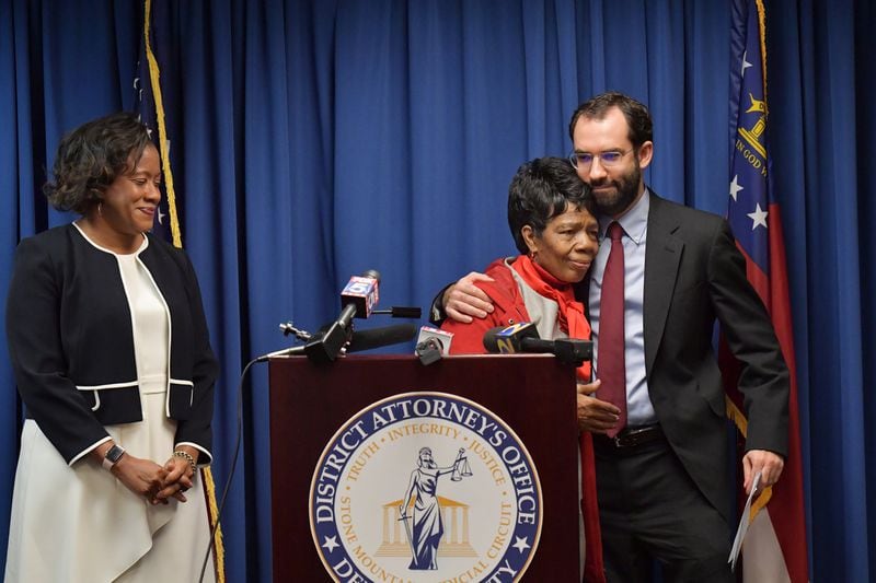 Defendant Christopher Williams’s mother Cathy White is comforted by attorney Aaron Littman (right) as DeKalb District Attorney Sherry Boston (left) looks on during a press conference at DeKalb County Superior Court in Decatur on Thursday, December 20, 2018.