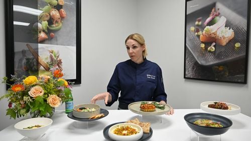 Chef Molly Brandt, Executive Chef of Culinary Innovation for North America at gategroup, explains In-flight dishes prepared for a tasting event at Gate Gourmet, Thursday, May 2, 2024, in Atlanta.  (Hyosub Shin / AJC)